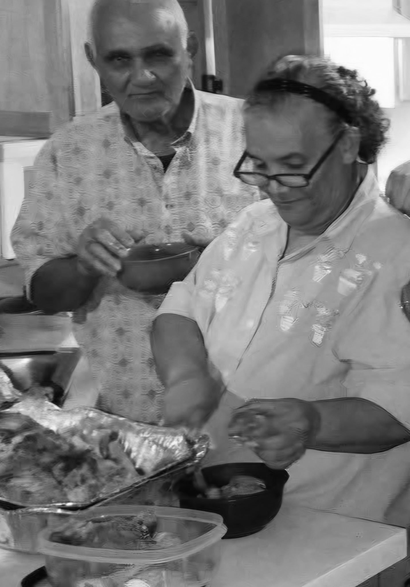 Maria and Moises preparing food together in the kitchen