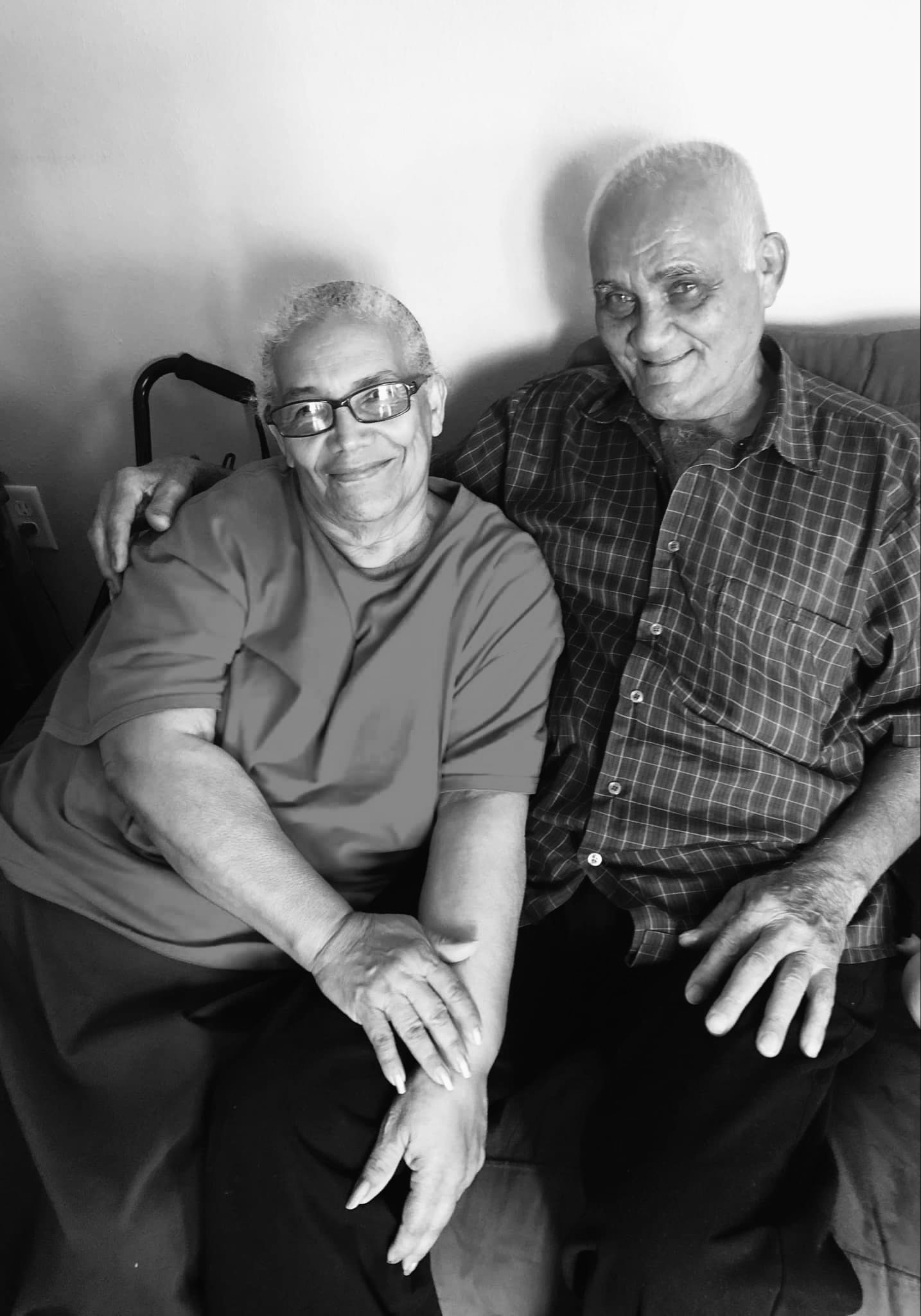 Maria and Moises sitting together on a sofa
