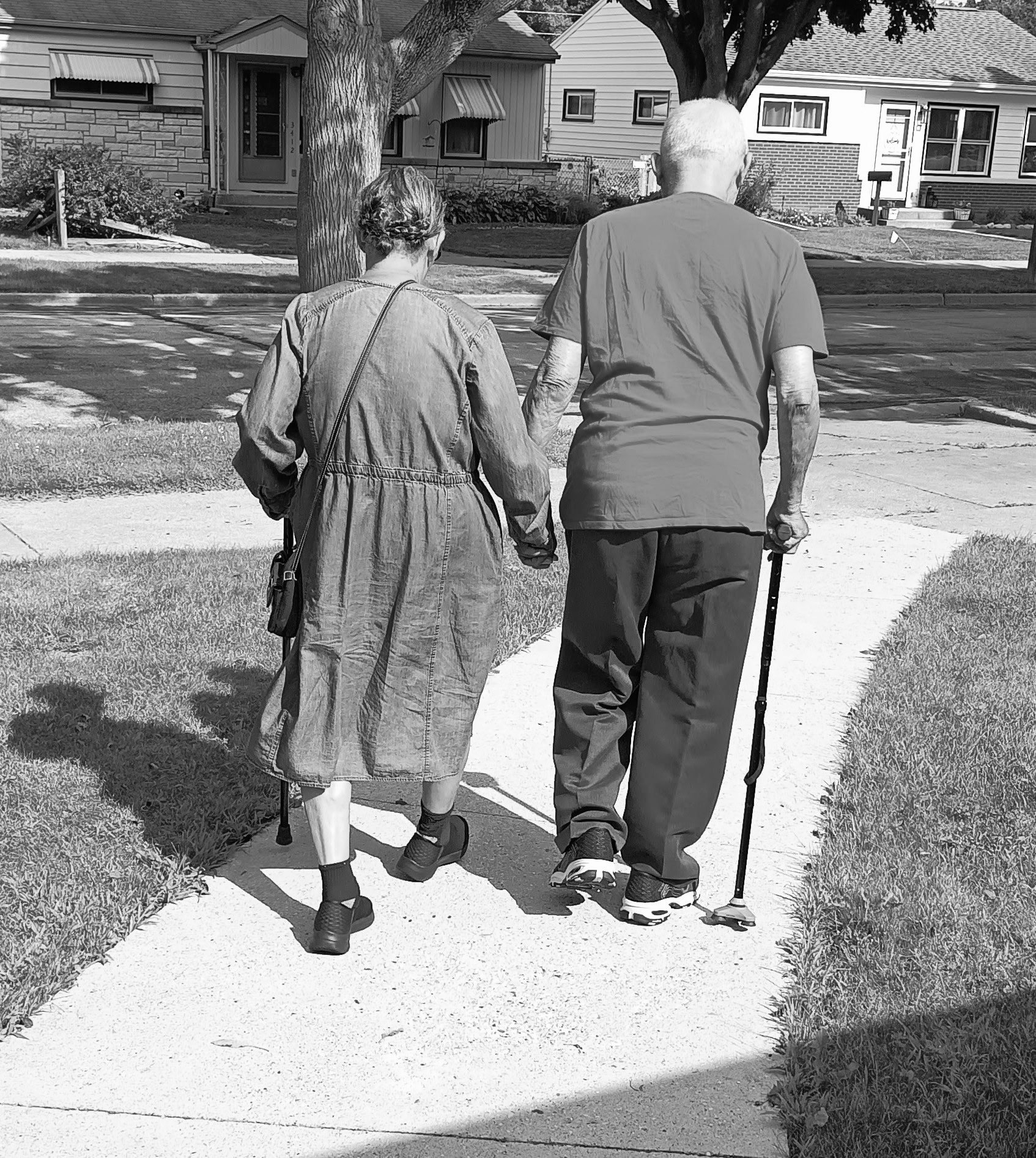 Maria and Moises walking hand in hand down the street